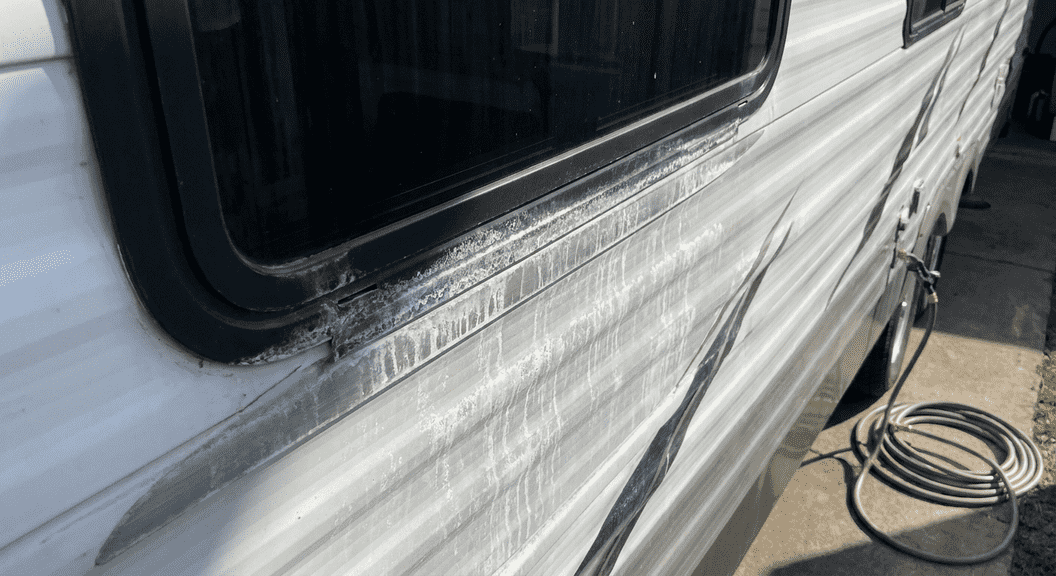 RV with white hard water stains on exterior surface